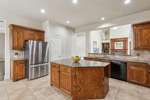 1016 Arches Park Dr, Allen, TX 75013 - kitchen with freestanding refrigerator, black dishwasher, a sink, a kitchen island, and decorative backsplash