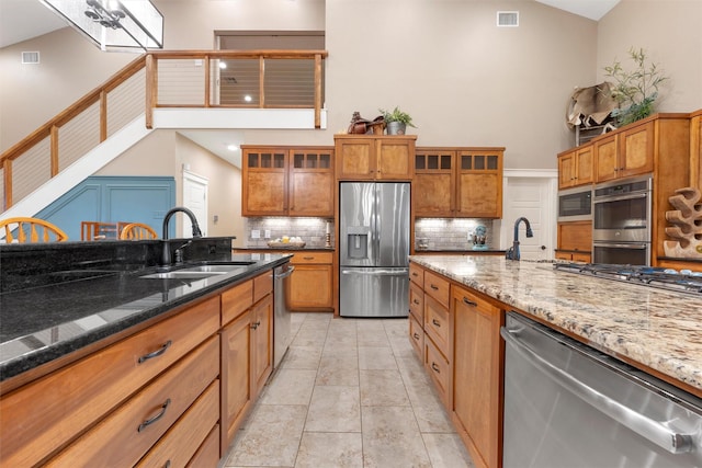 1009 Western Dr, Woodway, TX 76712 - kitchen with stainless steel appliances, a high ceiling, visible vents, and a sink