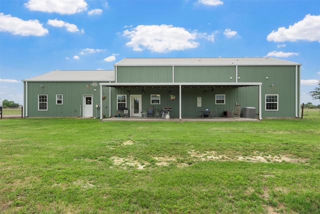 1009 Western Dr, Woodway, TX 76712 - rear view of property featuring fence, cooling unit, metal roof, a lawn, and an outbuilding