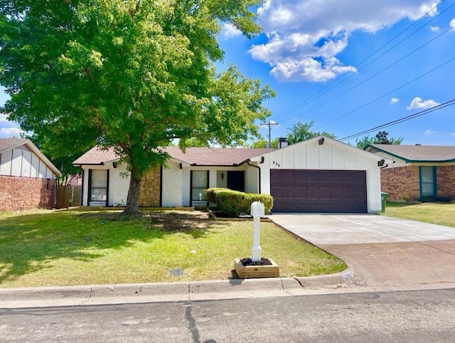 ranch-style home featuring an attached garage, board and batten siding, a front yard, and concrete driveway