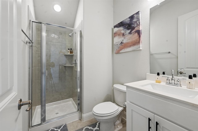 full bath featuring vanity, tile patterned floors, toilet, and a shower stall