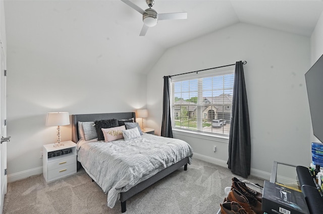 bedroom with light colored carpet, a ceiling fan, baseboards, and lofted ceiling
