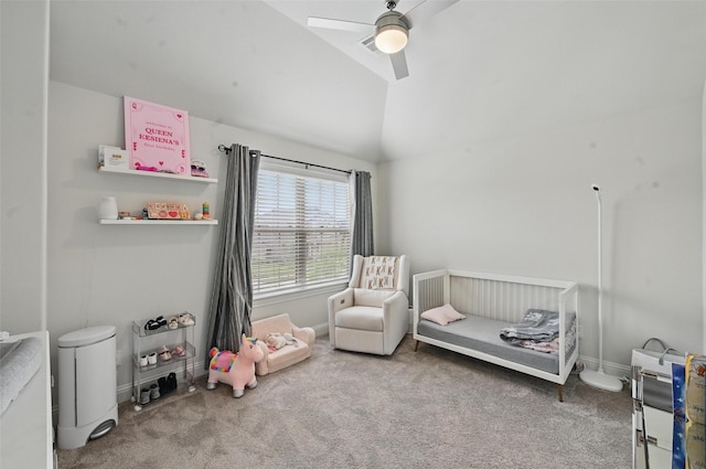bedroom with lofted ceiling, baseboards, a nursery area, a ceiling fan, and carpet