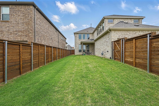 view of yard with a fenced backyard