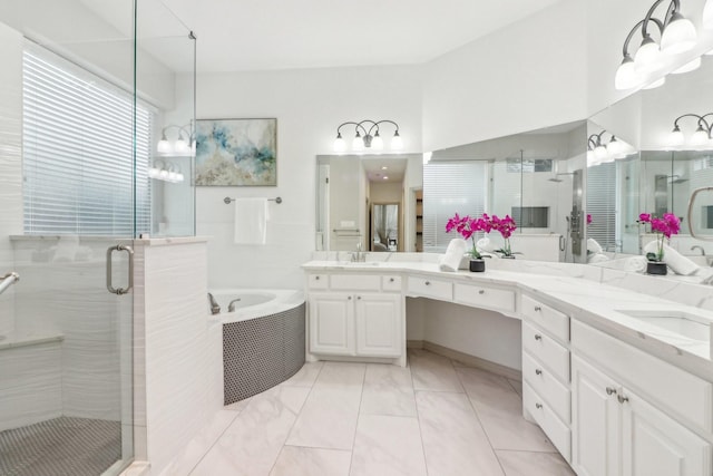 full bathroom with marble finish floor, a shower stall, a bath, and vanity