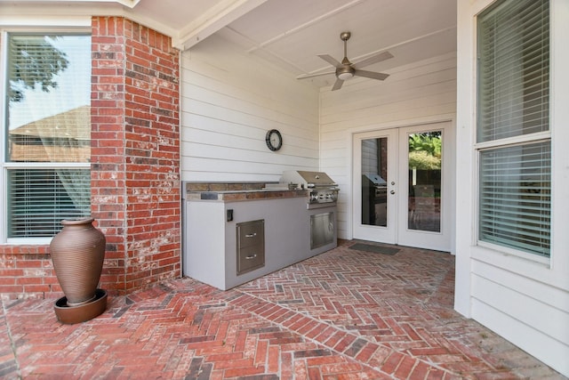 view of patio / terrace with grilling area, exterior kitchen, ceiling fan, and french doors