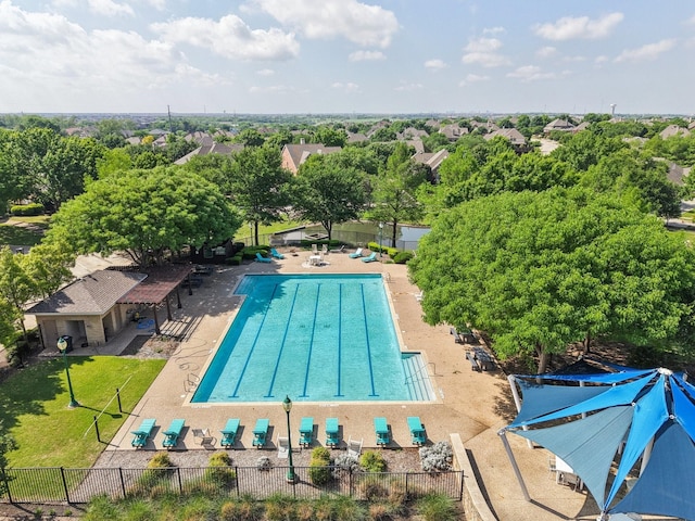 community pool with a patio and fence
