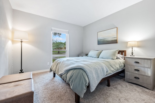 bedroom featuring baseboards and light carpet