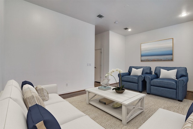 living room featuring recessed lighting, baseboards, visible vents, and wood finished floors