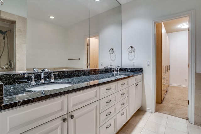 bathroom featuring a sink, tile patterned floors, a shower, and double vanity