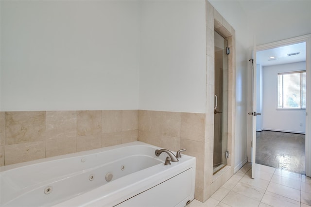 bathroom with a jetted tub, a shower stall, and visible vents