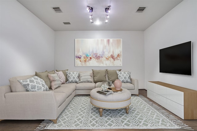 living room featuring visible vents and wood finished floors