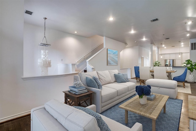 living room featuring recessed lighting, baseboards, visible vents, and wood finished floors