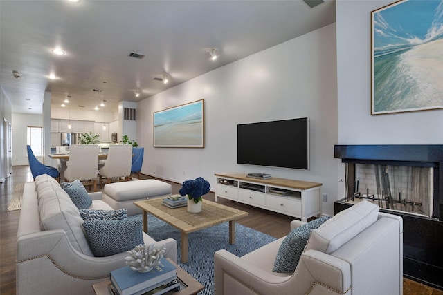 living room with recessed lighting, visible vents, and dark wood-style floors