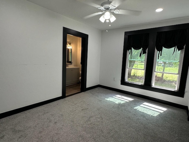 spare room with a ceiling fan, a sink, baseboards, carpet, and recessed lighting