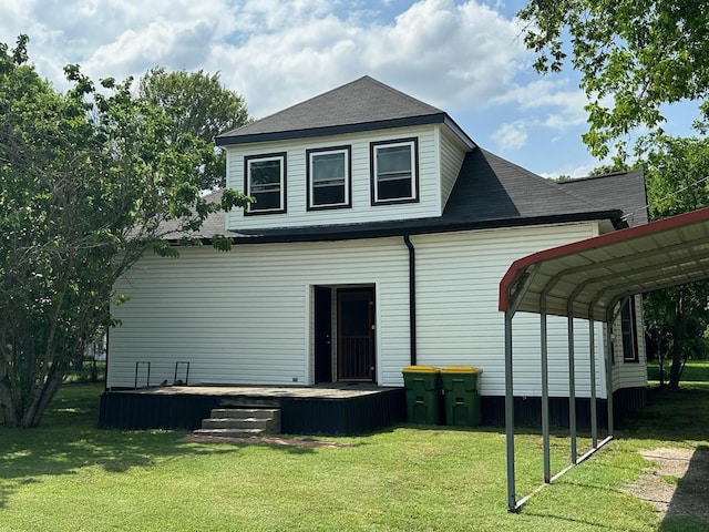 back of property with a lawn, a wooden deck, and roof with shingles