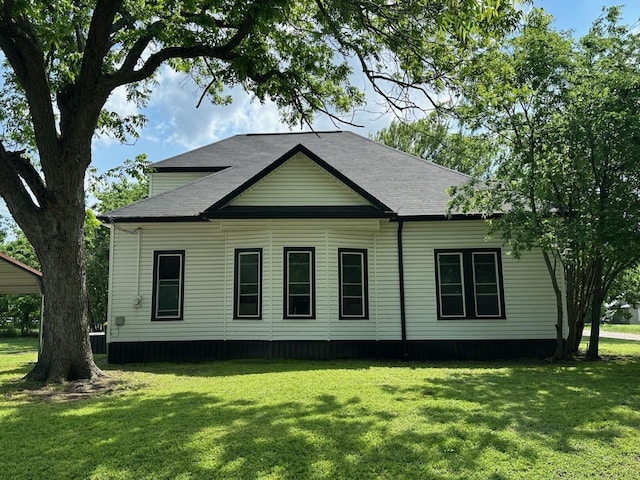 rear view of house with a yard