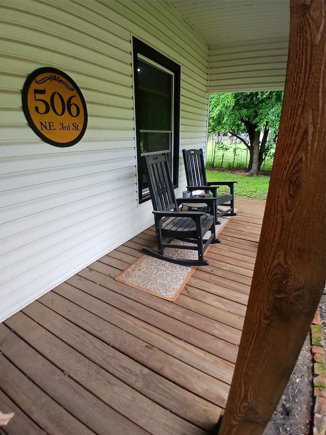 wooden terrace with a porch