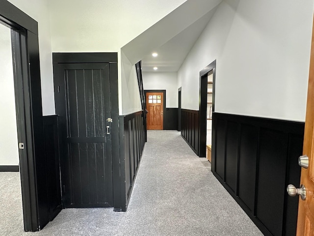 corridor featuring carpet floors, wainscoting, and recessed lighting