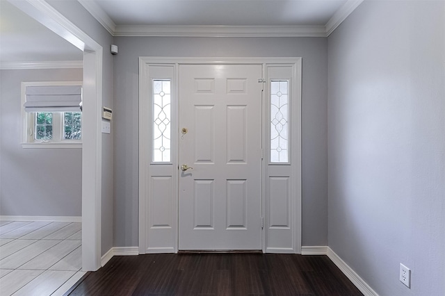 foyer with crown molding, baseboards, and dark wood-type flooring