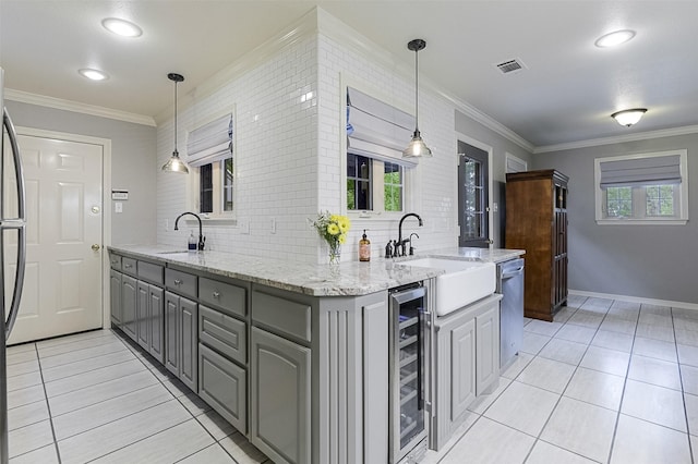 kitchen featuring visible vents, crown molding, gray cabinetry, beverage cooler, and light tile patterned flooring
