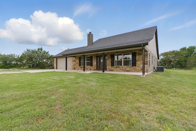 view of front of house with a garage, a front yard, stone siding, a chimney, and concrete driveway