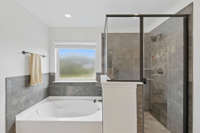 bathroom with a bath and a stall shower