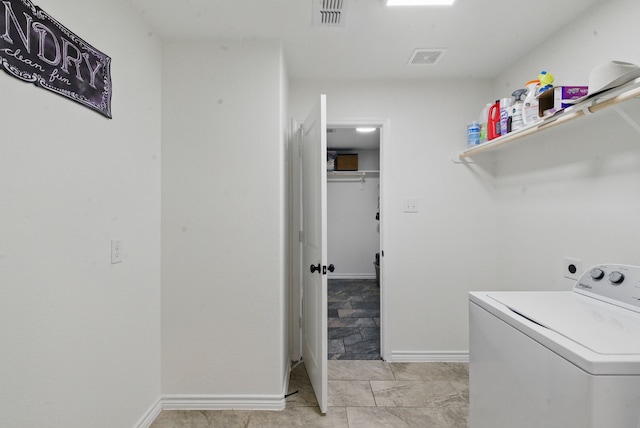 laundry area featuring visible vents, laundry area, washer / dryer, and baseboards