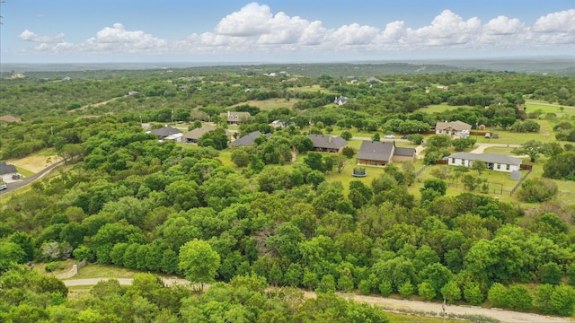 drone / aerial view featuring a view of trees and a residential view