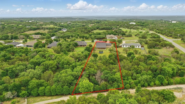 drone / aerial view with a wooded view