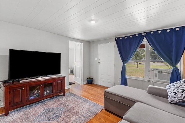 living area with wood ceiling, wood finished floors, and cooling unit