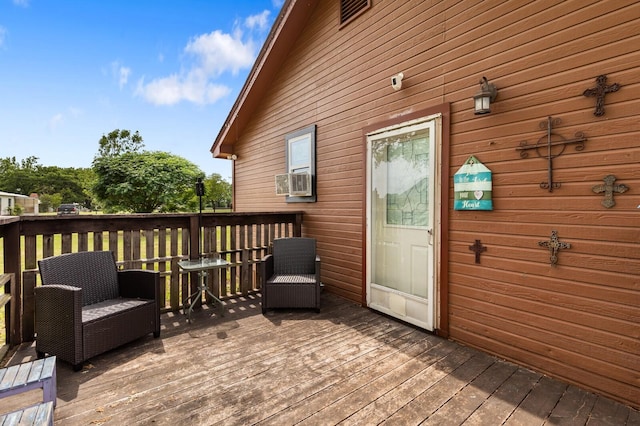 wooden terrace featuring cooling unit