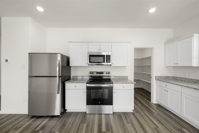 4936 Bass Dr, Fort Worth, TX 76179 - kitchen with appliances with stainless steel finishes, dark wood-style floors, white cabinets, light stone counters, and recessed lighting