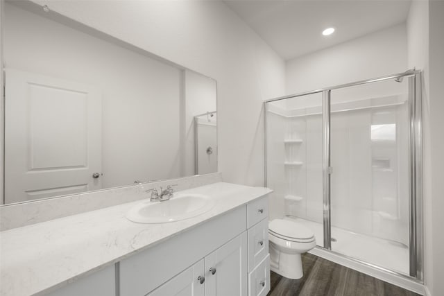 4936 Bass Dr, Fort Worth, TX 76179 - bathroom with a shower stall, vanity, toilet, wood finished floors, and recessed lighting