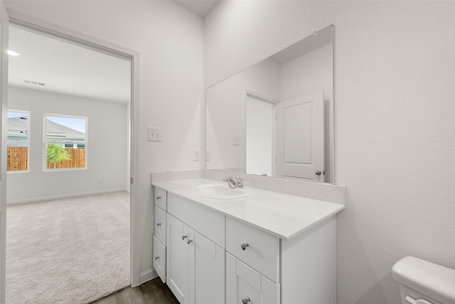4936 Bass Dr, Fort Worth, TX 76179 - half bathroom featuring vanity, toilet, wood finished floors, and baseboards
