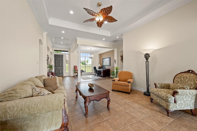 living area featuring light tile patterned flooring, ornamental molding, recessed lighting, a ceiling fan, and a tray ceiling