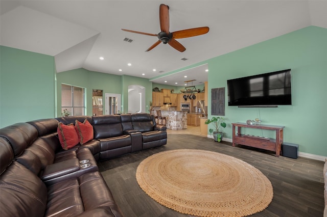 living area with vaulted ceiling, arched walkways, ceiling fan, wood finished floors, and recessed lighting