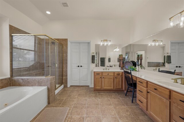 full bathroom with a shower stall, a garden tub, vanity, and a high ceiling