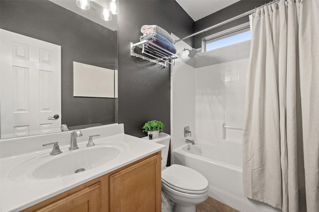 full bath with a textured wall, toilet, shower / bath combo with shower curtain, and vanity