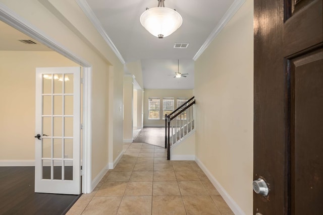 hallway featuring baseboards, stairs, and visible vents