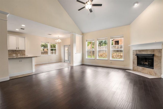 2719 Foxpoint Trl, Arlington, TX 76017 - unfurnished living room featuring a fireplace, a chandelier, a ceiling fan, wood finished floors, and recessed lighting