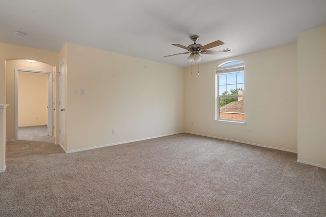 spare room with baseboards, carpet flooring, and ceiling fan