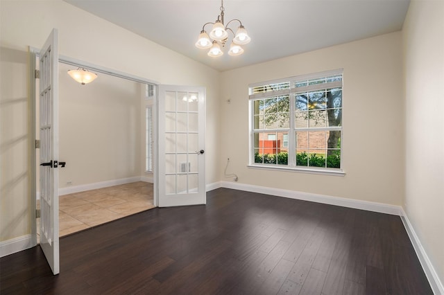2719 Foxpoint Trl, Arlington, TX 76017 - spare room featuring french doors, dark wood-style floors, a chandelier, baseboards, and lofted ceiling