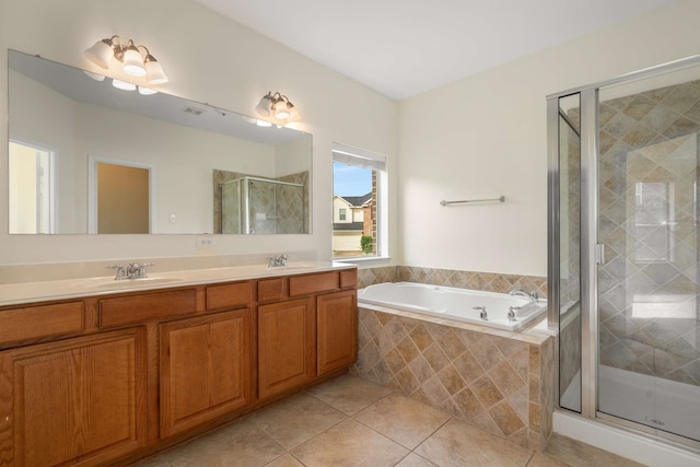 full bathroom featuring a sink, tile patterned floors, a shower stall, and a bath