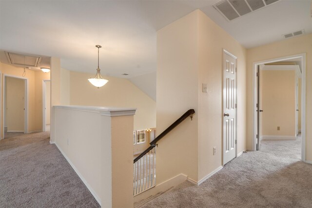 2719 Foxpoint Trl, Arlington, TX 76017 - corridor with an upstairs landing, attic access, carpet flooring, and baseboards