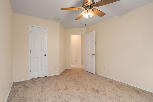 unfurnished bedroom featuring a ceiling fan, baseboards, visible vents, and carpet