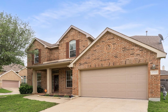 traditional-style home featuring brick siding, a shingled roof, an attached garage, and driveway