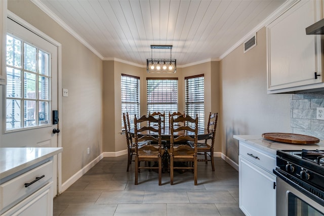 dining space featuring crown molding, baseboards, visible vents, and wood ceiling