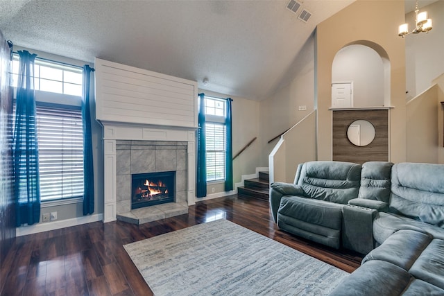 living area with stairway, vaulted ceiling, a wealth of natural light, and visible vents