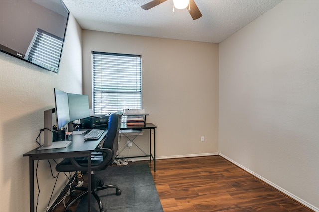 office area featuring a textured ceiling, ceiling fan, baseboards, and wood finished floors